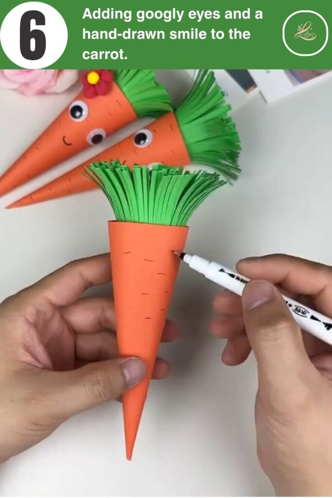 Decorating a paper carrot with googly eyes and a marker.