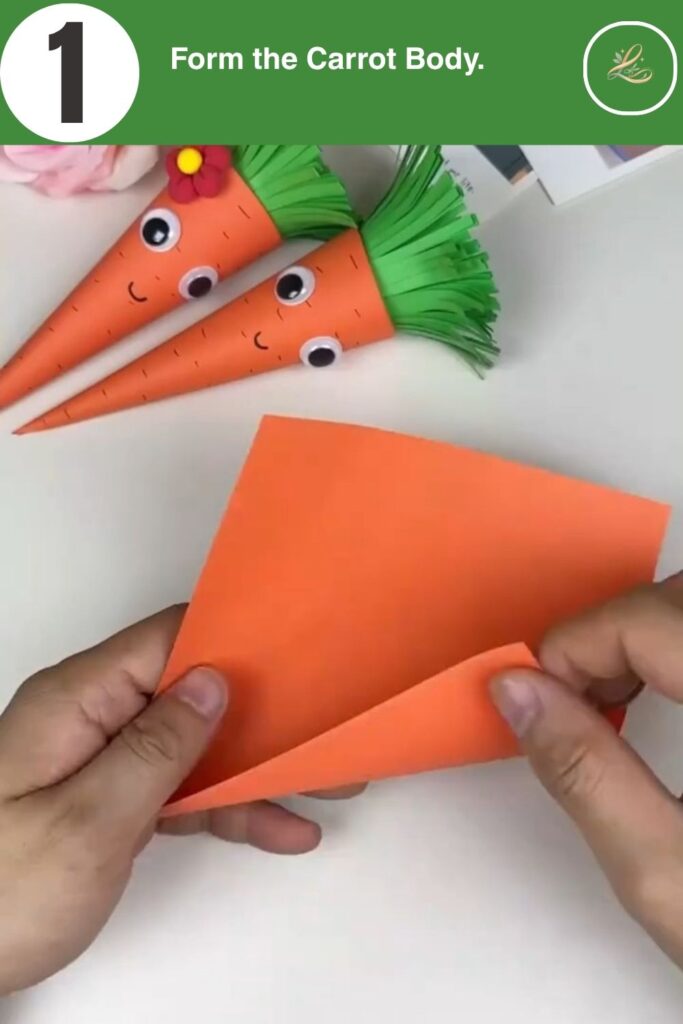 Rolling orange cardstock into a cone for a paper carrot craft.