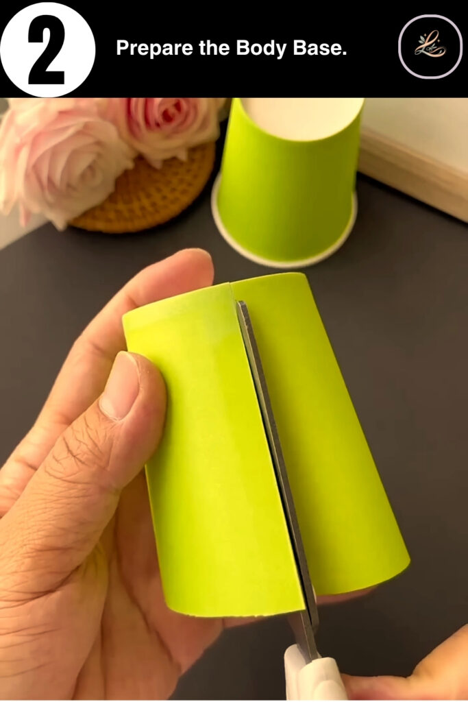 Making a vertical slit in a paper cup for the puppet body.