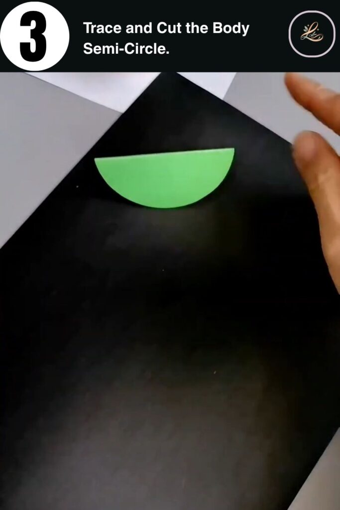 Green cardstock semi-circle cut out as the body of a DIY paper snail craft