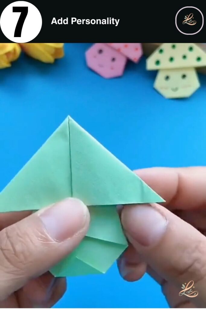 A completed green paper mushroom with blue dots and a smiling face.