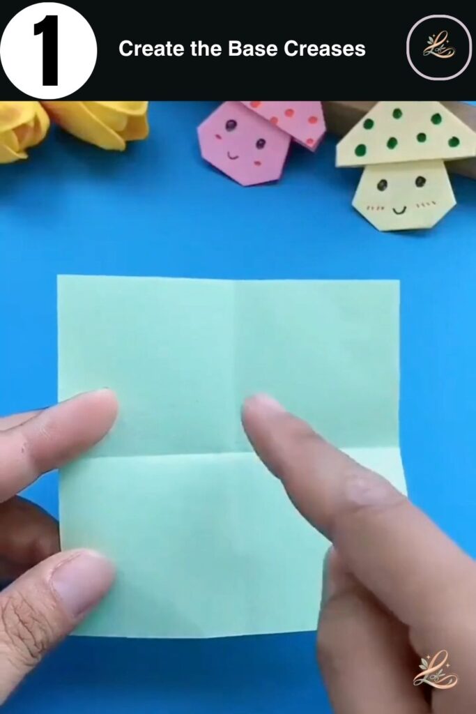 A square piece of green origami paper with cross-shaped creases in the center