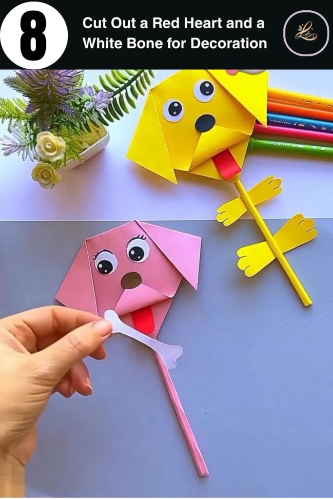 Completed DIY paper dog pencil topper held up showing heart topper and bone on stick decoration