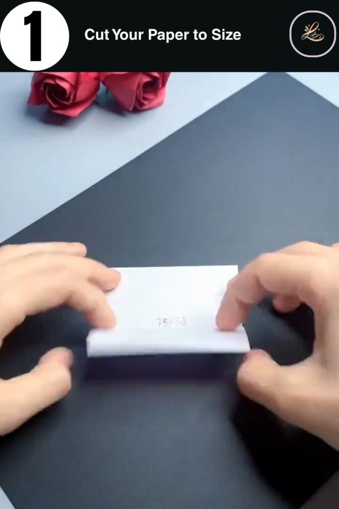 Hands holding a 7.5 cm square of paper with measurement written on it for paper bunny ring craft