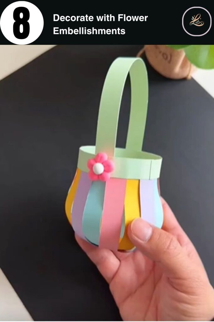 Pink flower embellishment being added to the rim of a finished DIY paper basket craft for kids