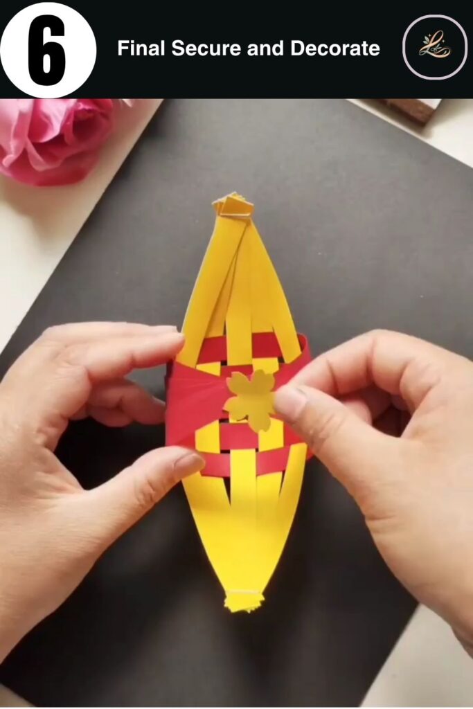 The completed woven paper boat in red and yellow.