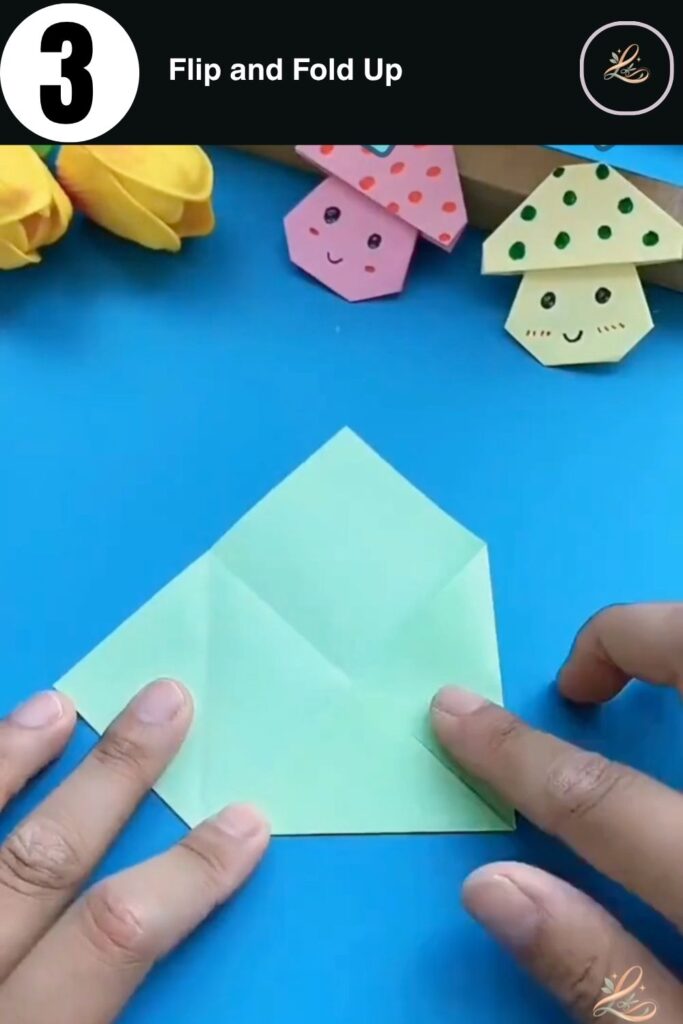 Green paper flipped over with the bottom section folded halfway up.