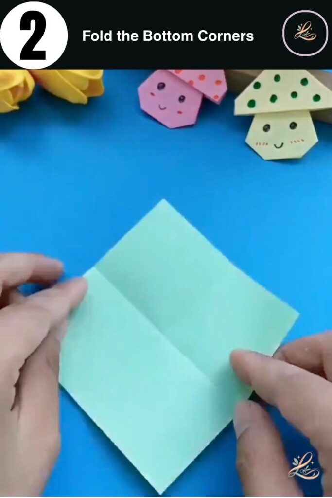Bottom corners of green paper folded to the center crease.