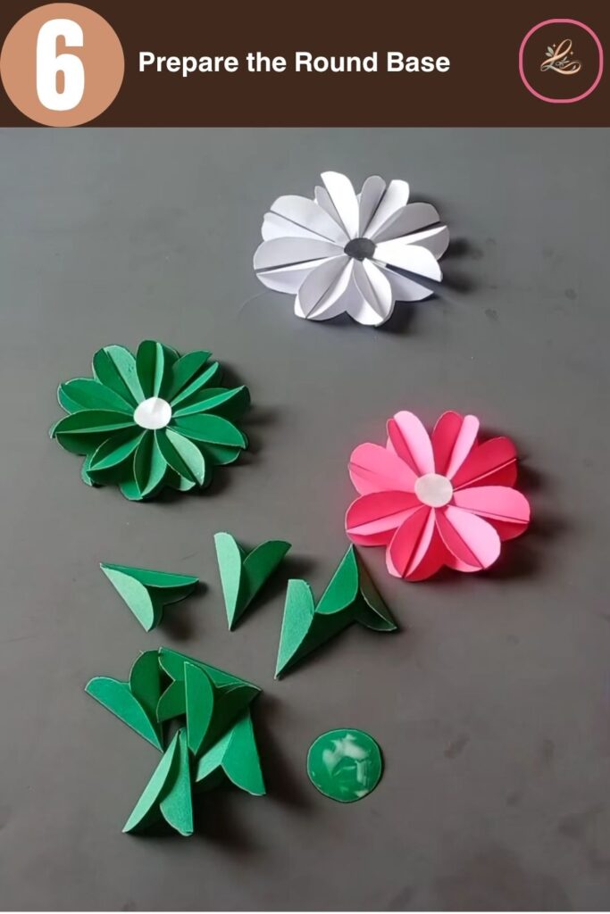 Pretty Paper Daisy Flower Craft for Kids Applying a thin layer of craft glue onto a small circular green paper base cutout.