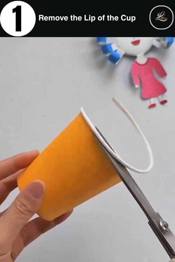 Adorable Paper Cup Doll Craft for Beginners A close-up of hands using scissors to trim away the rim of a yellow paper cup for crafting.