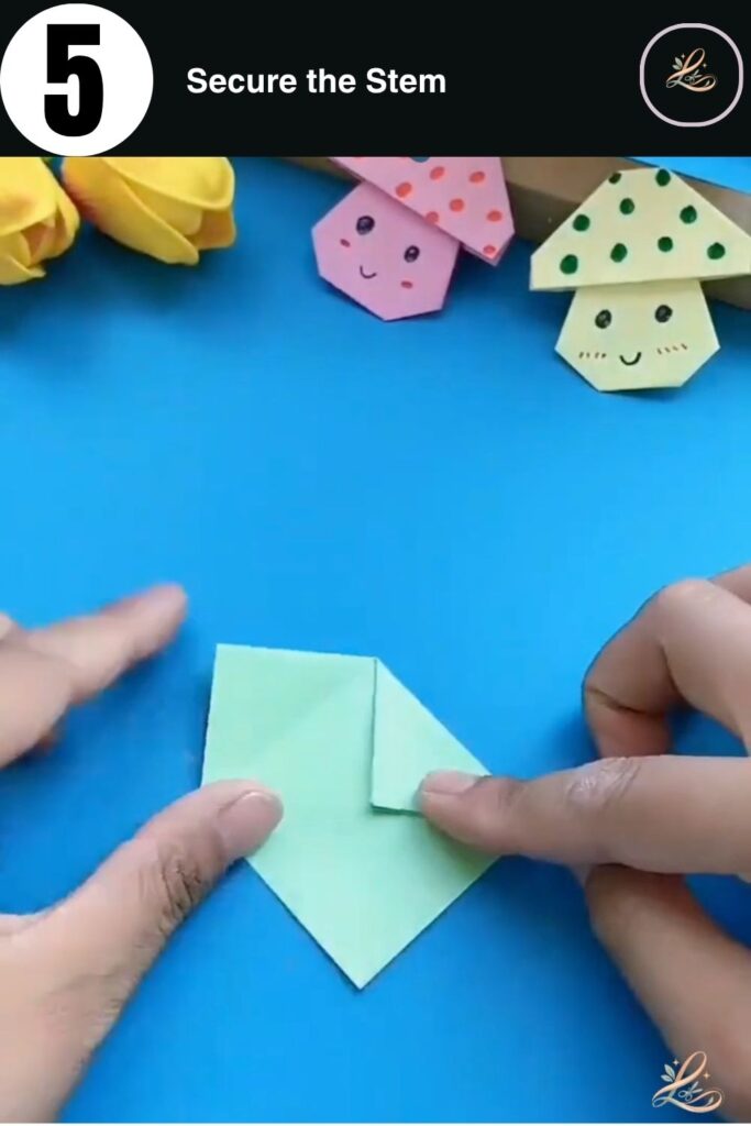 Creating the mushroom stem by folding the side flaps inward.