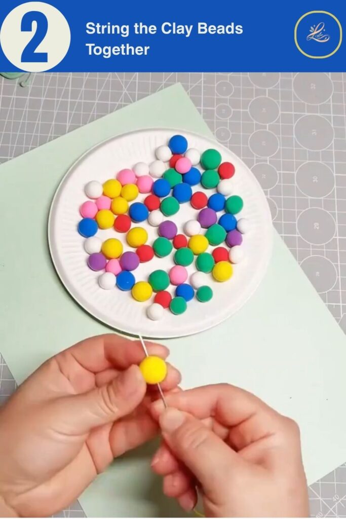 Colorful Cup Wind Chime Mobile for Beginners (DIY Decor) Threading a needle and string through colorful handmade clay beads.