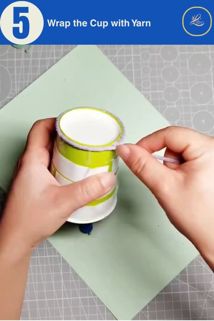 Colorful Cup Wind Chime Mobile for Beginners (DIY Decor) Wrapping purple yarn around a sticky paper cup to create texture.