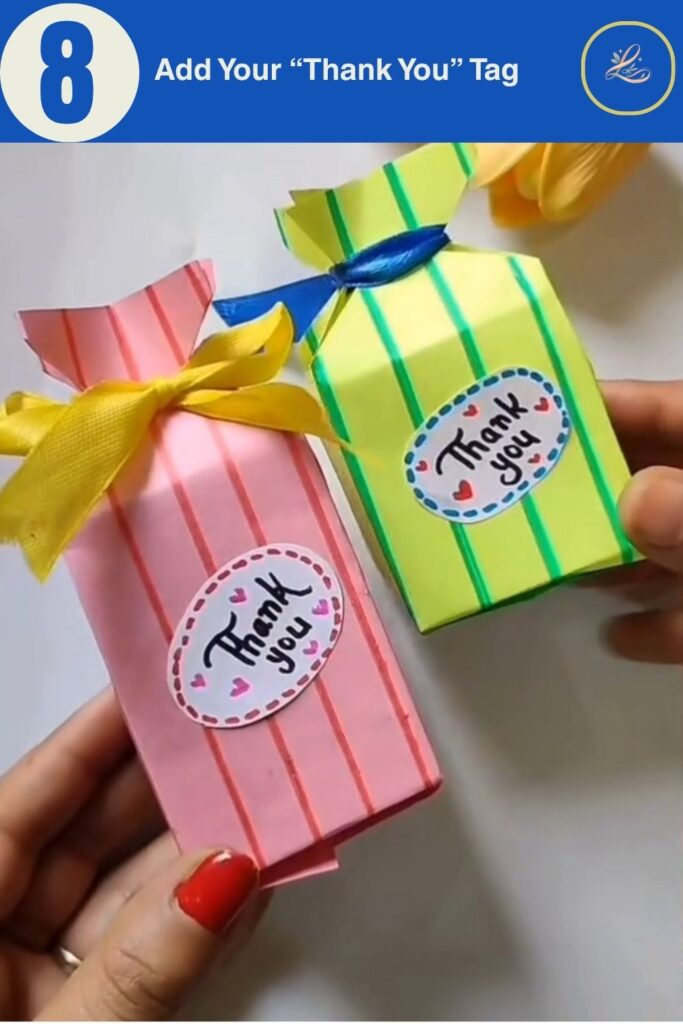 Finished handmade birthday paper gift bags in pink and green with ribbon bows and Thank You tags