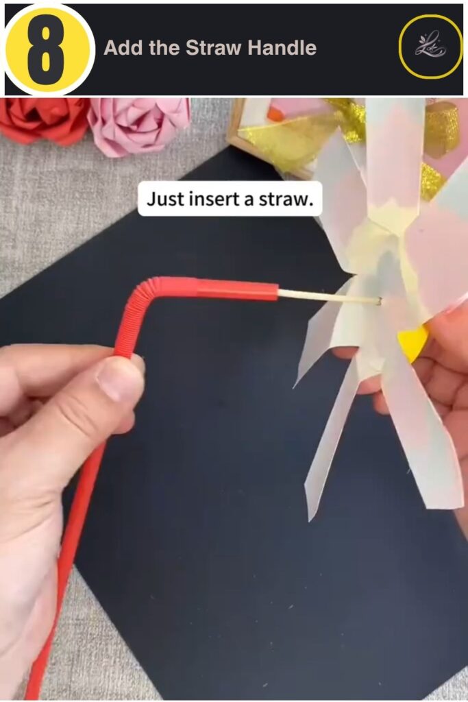 Finished rainbow paper cup pinwheel craft for kids with red straw handle, spinning