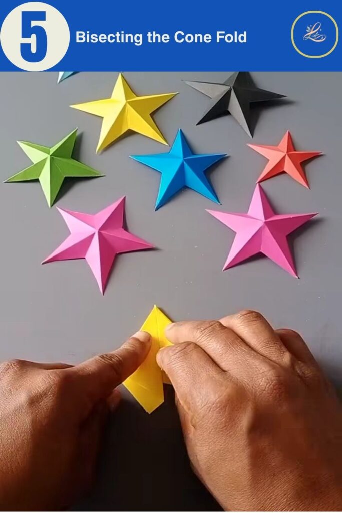 Bisecting the folded paper cone to prepare for the scissor cut.