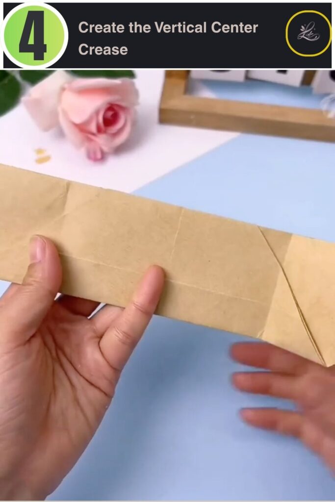Folding the origami bat structure in half vertically to create a spine.