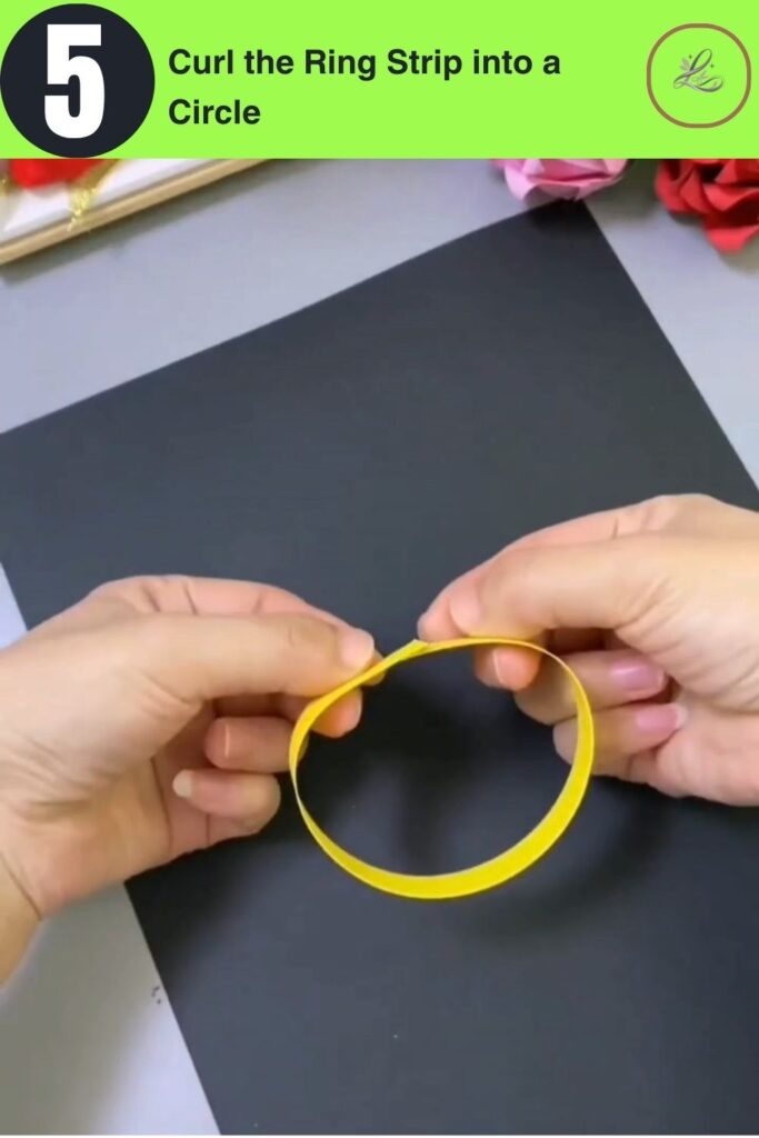 Fun Rainbow Woven Paper Pencil Holder DIY (#1) Hands curling a yellow paper strip into a circle to form a horizontal ring for weaving a DIY paper pencil holder