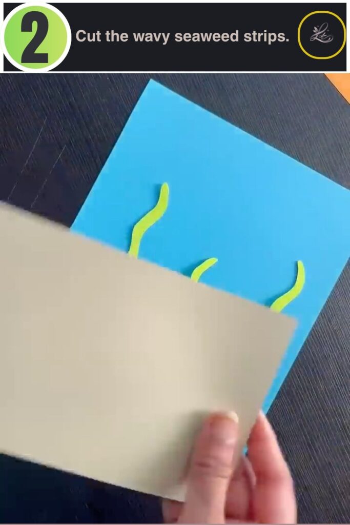 Green cardstock seaweed strips cut for a paper aquarium craft