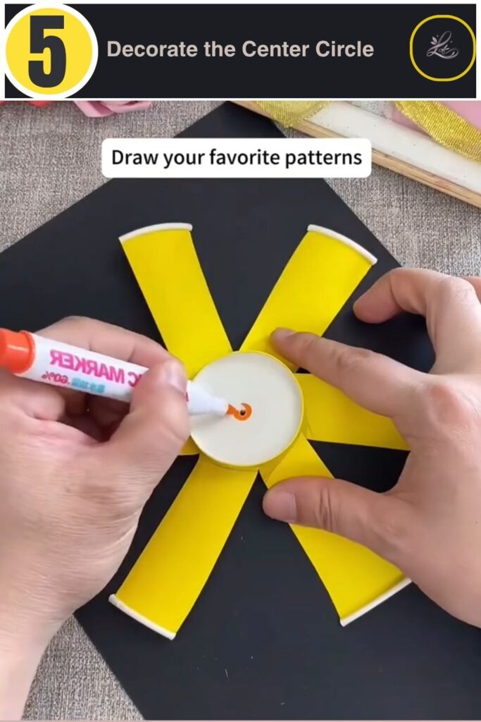 Decorating the center circle of a paper cup pinwheel with rainbow marker dots