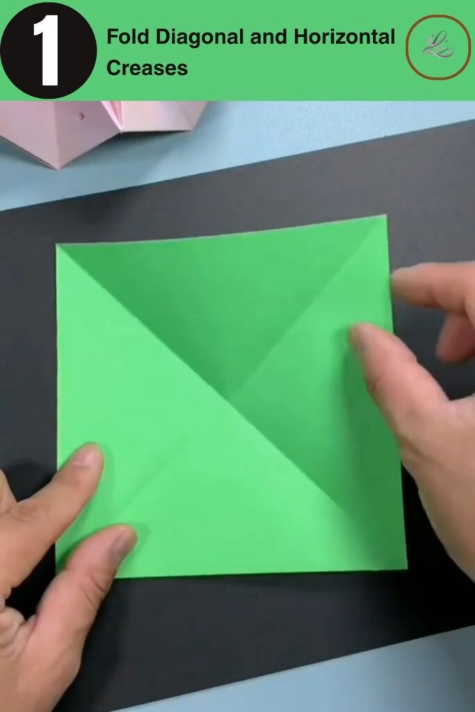 Creating diagonal and horizontal crease lines on a green square origami paper sheet.
