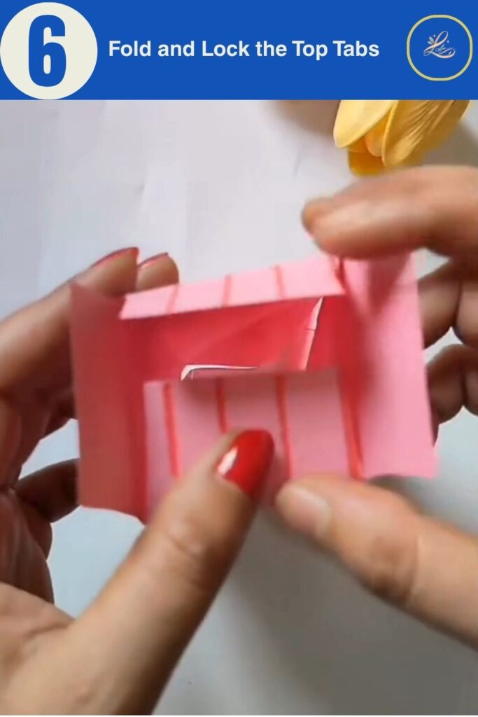 Folding and locking paper tabs closed at the top of a handmade birthday paper gift bag