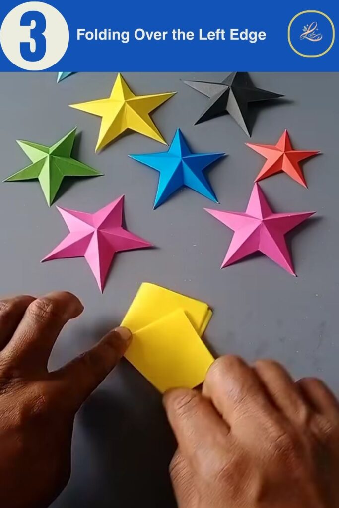 Folding the left flap over the center crease during origami star assembly.