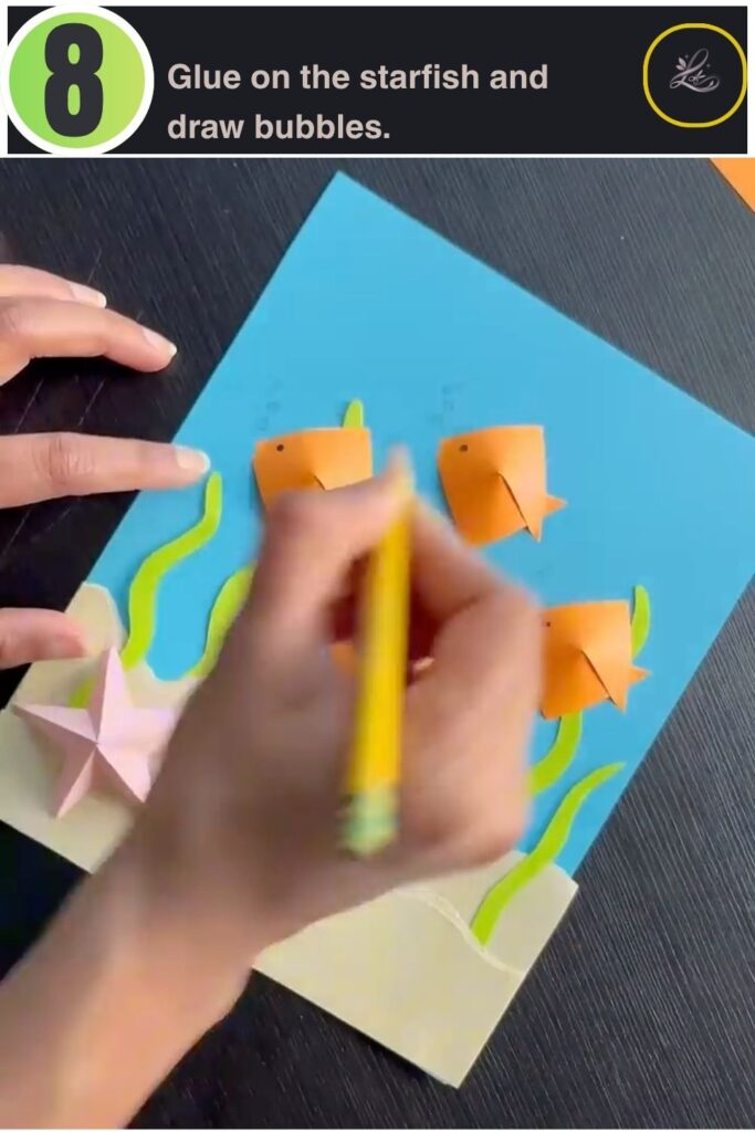 Finished paper fish tank craft with origami fish, seaweed, and starfish