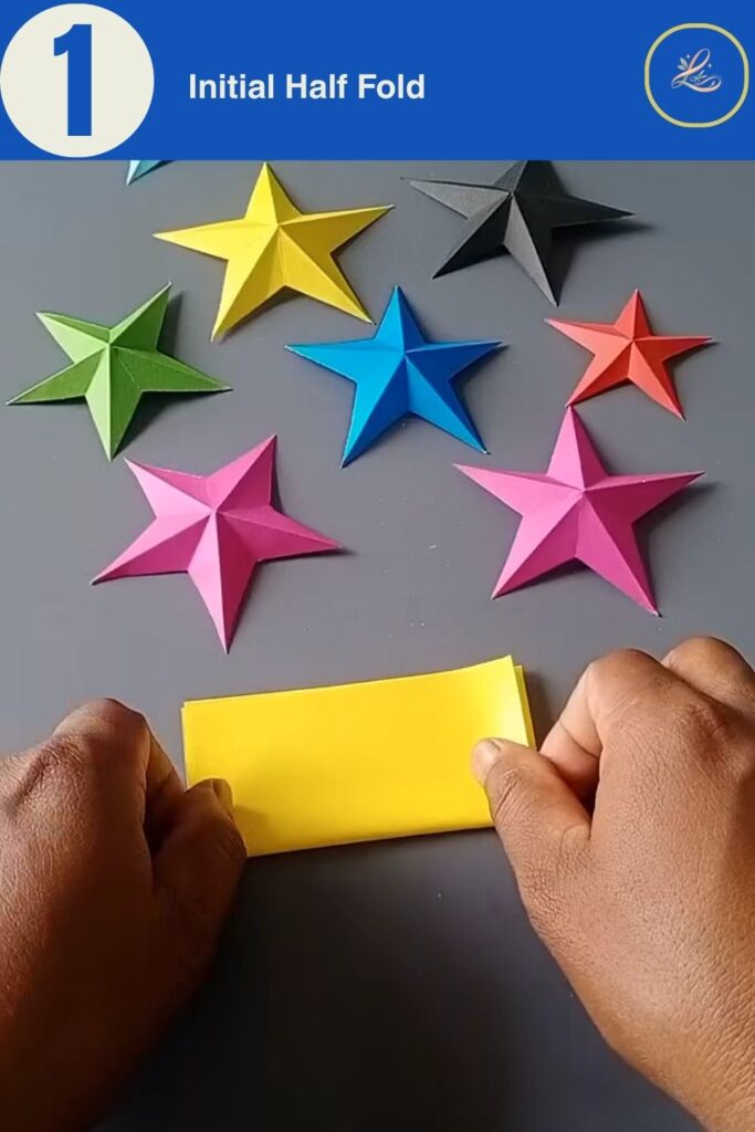 Folding a yellow sheet of paper horizontally in half for an origami paper star craft.