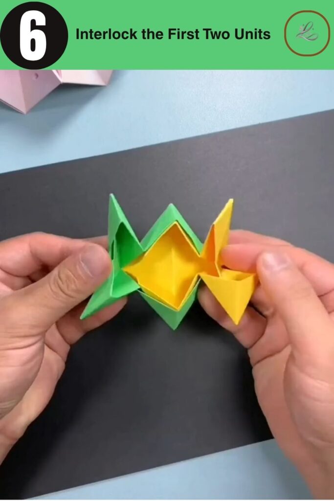 Inserting the tip of one origami unit into the open pocket of another.