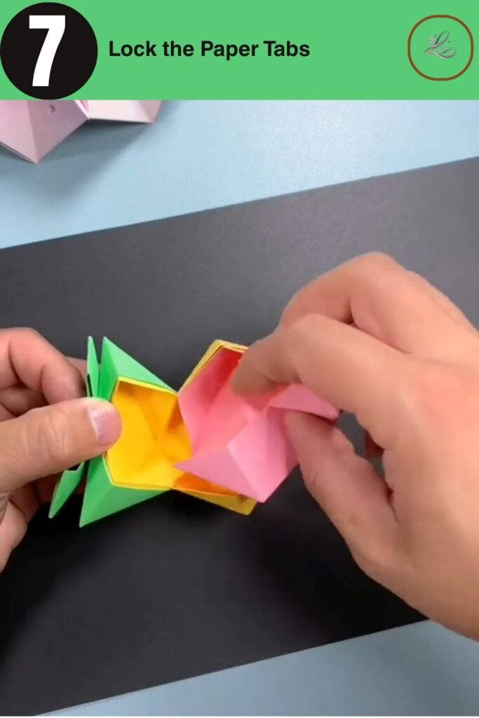 Folding and locking paper tabs to connect modular origami pieces together.