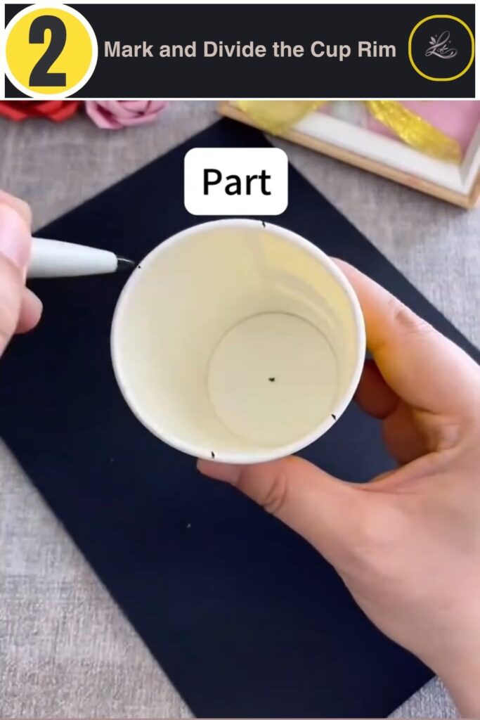 Marking six even sections on a paper cup rim before cutting petals