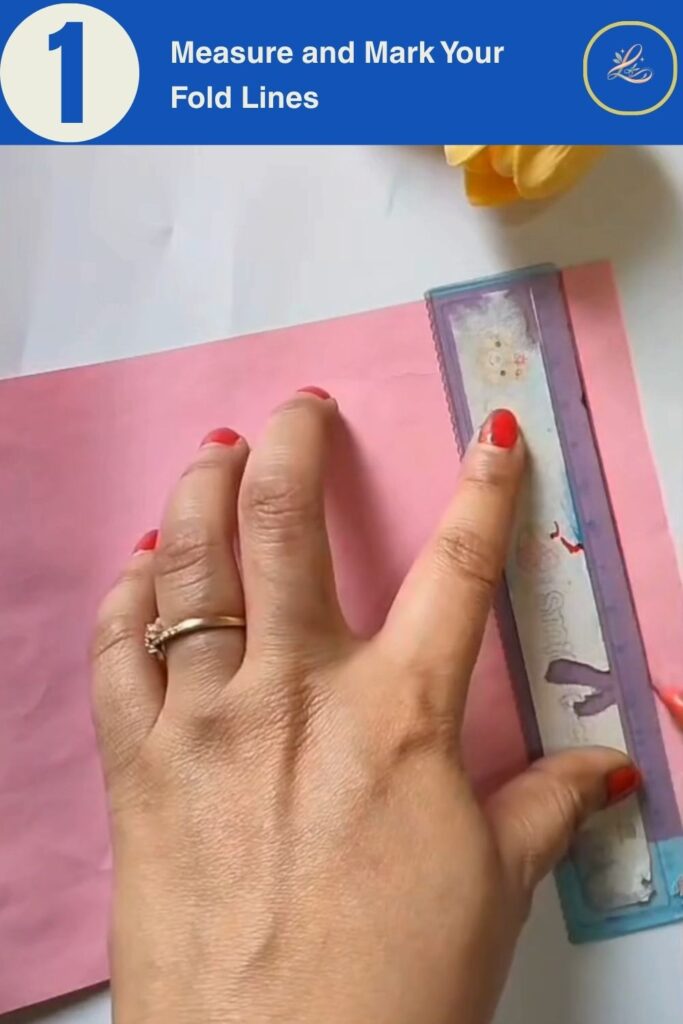 Pink cardstock with ruler marking vertical fold lines for a DIY birthday paper gift bag