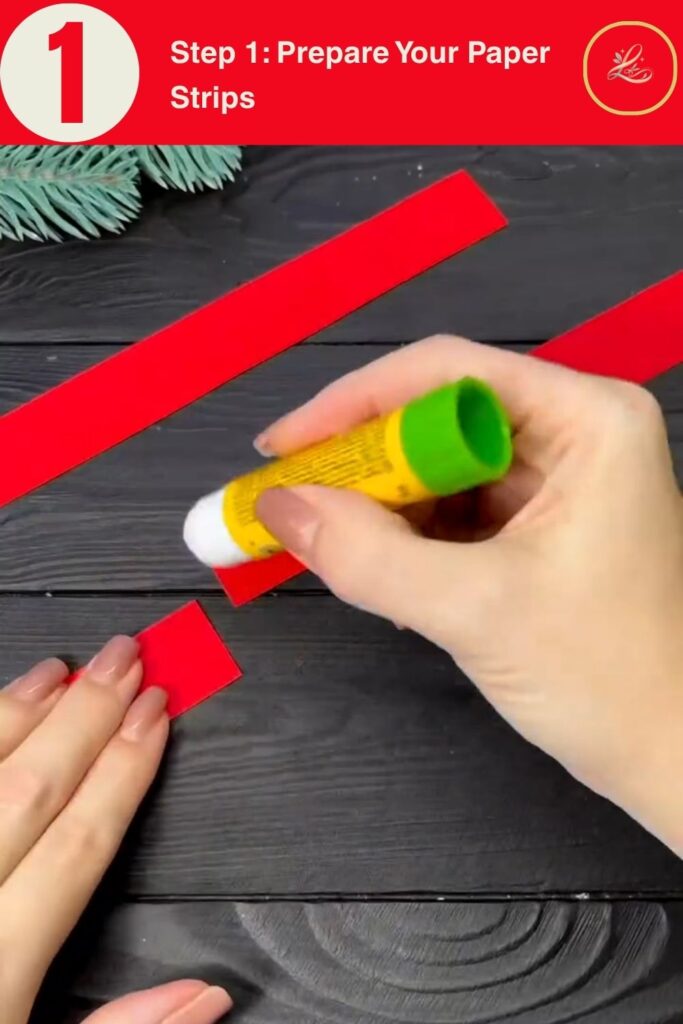Two red cardstock strips and a yellow glue stick on a dark wood surface, materials for a DIY paper star Christmas ornament tutorial