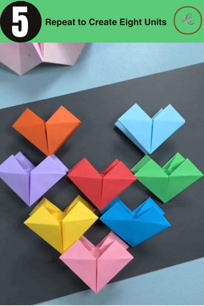 Eight colorful completed modular origami units arranged in a row.
