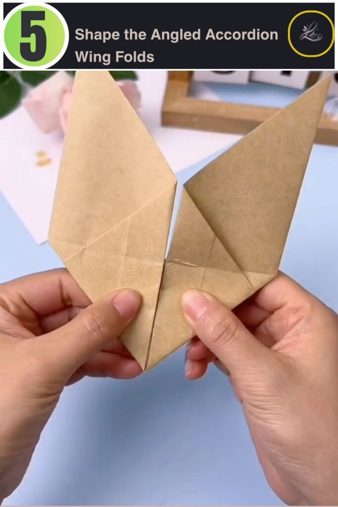 Pleating the craft paper into accordion folds to shape the bat wings.