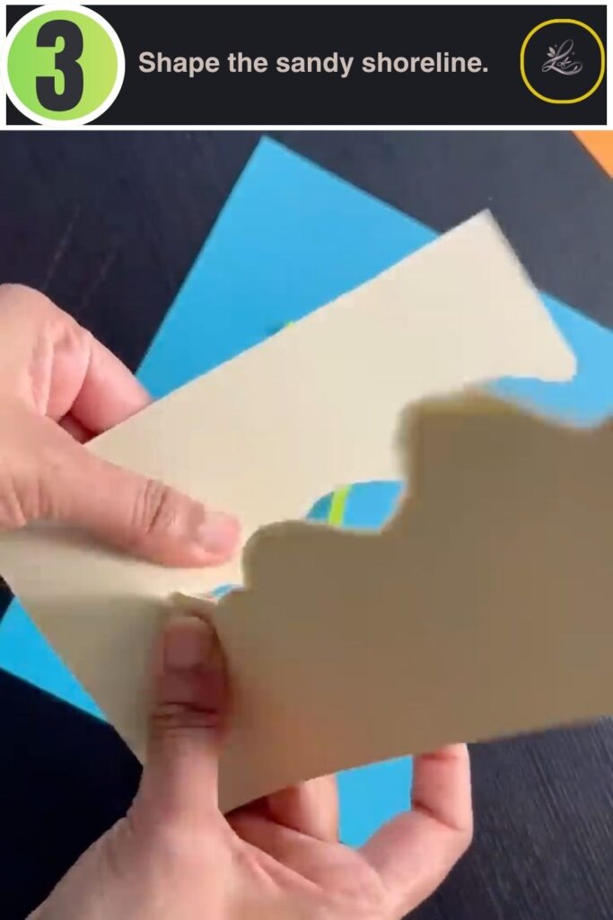 Tan cardstock being shaped into a wavy sand shoreline for a paper fish tank