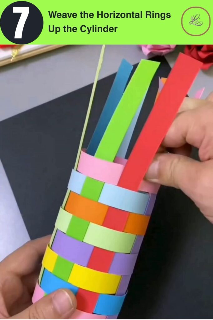 Fun Rainbow Woven Paper Pencil Holder DIY (#1) Colorful woven paper cylinder mid-build with multiple rainbow-colored rings in a basket-weave pattern DIY paper pencil holder in progress