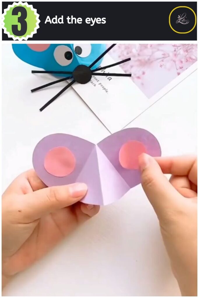 Adorable Paper Mouse Craft For Beginners Gluing black and white paper eyes onto the paper mouse craft.