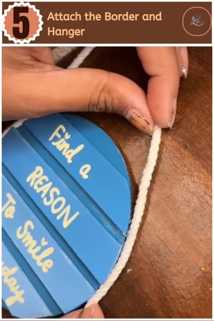 Cute DIY Inspirational Wall Hanging Anyone Can Make Gluing a white macrame rope border around the edge of a round painted sign.