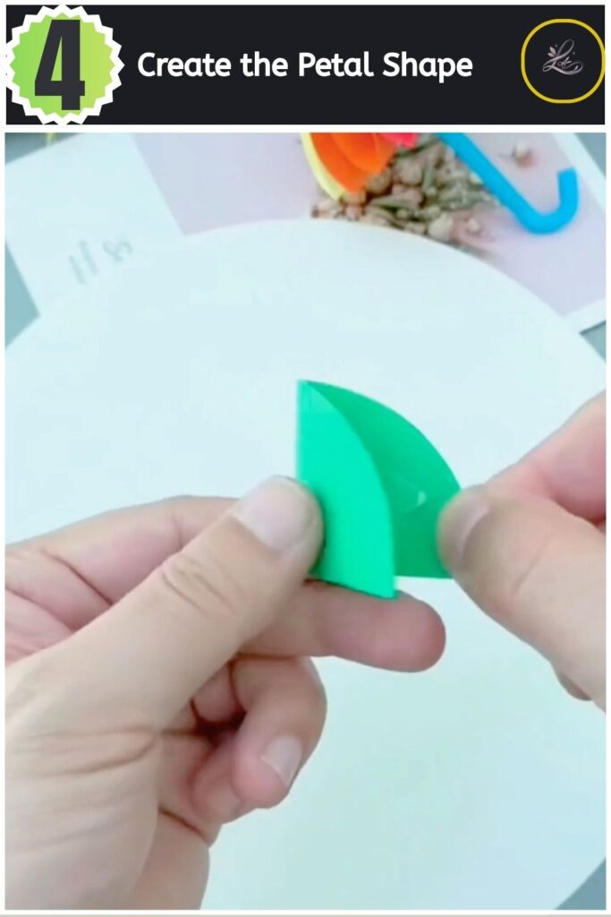 Shaping the folded green paper into a yellow petal shape