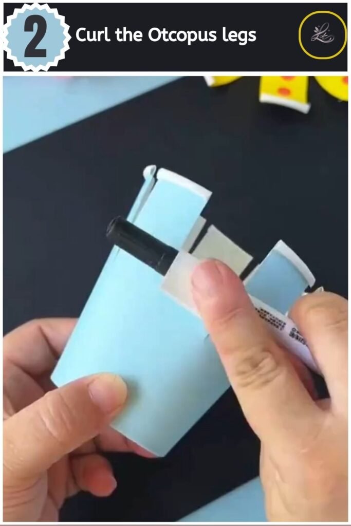 Playful Paper Cup Octopus Craft for Beginners Curling the cut strips of a paper cup outward using a black marker.