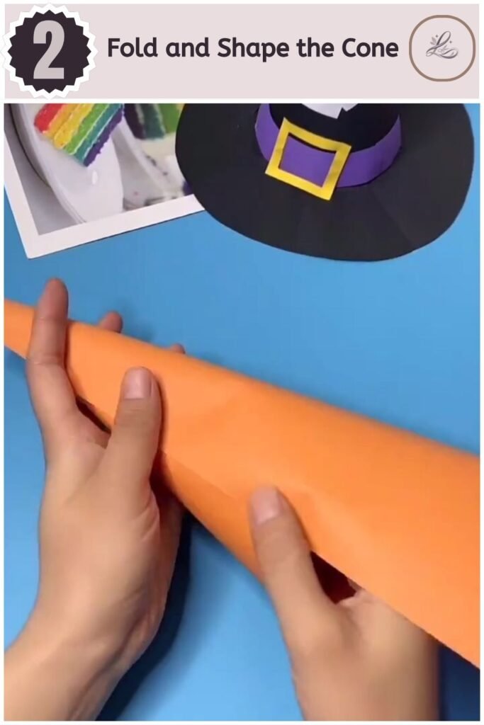 Adorable Halloween Paper Hat Craft for Beginners Hands folding orange cardstock into a cone shape for a witch hat craft