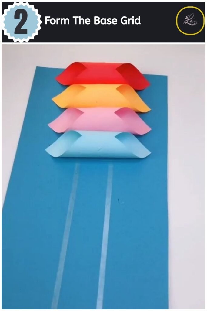 Beautiful Handmade Paper Lantern Craft A colourful row of paper tubes glued onto a blue cardstock base sheet.