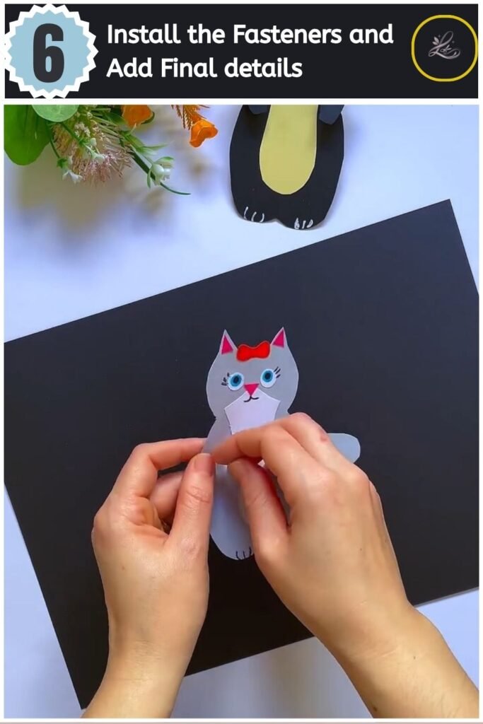 Cute Paper Cat Peekaboo Toy Step by Step Inserting a metal brad fastener to attach the arm to the paper cat body.