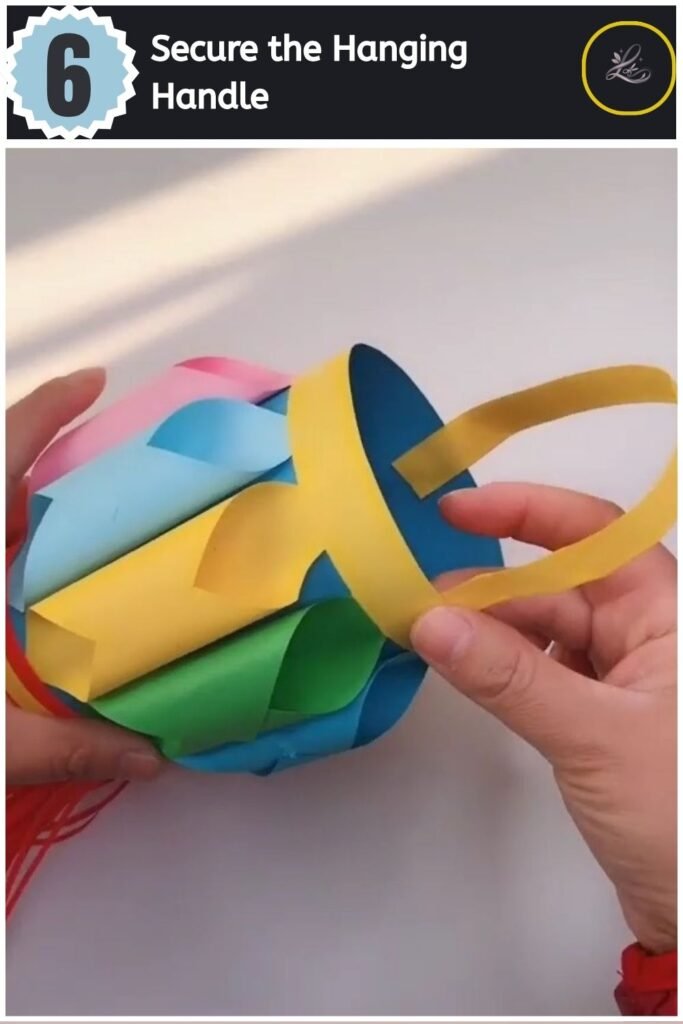 Beautiful Handmade Paper Lantern Craft The finished colourful DIY paper lantern hanging by its yellow paper loop handle.