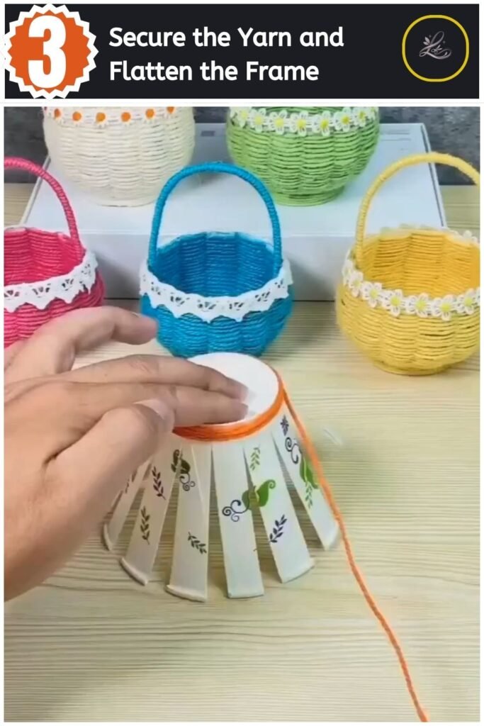 Paper cup slats flattened out on a table with orange yarn starting to weave in the center.