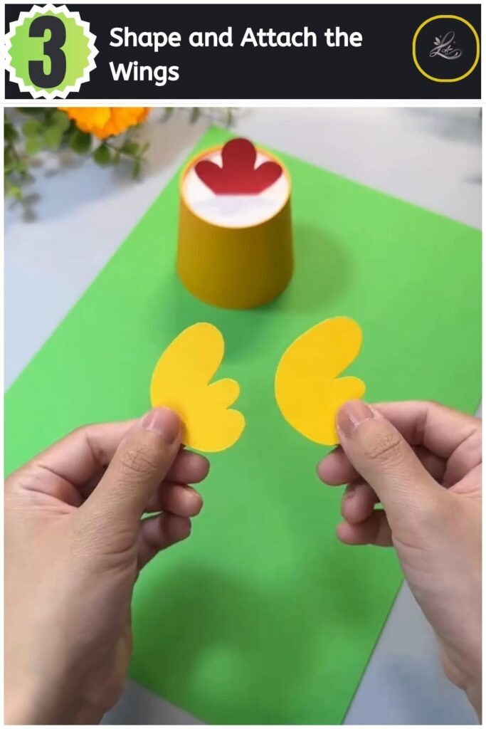 Adorable Paper Cup Chicken Craft for Beginners (#1) Inserting a yellow cardstock wing cutout into the side slot of a paper cup chicken.
