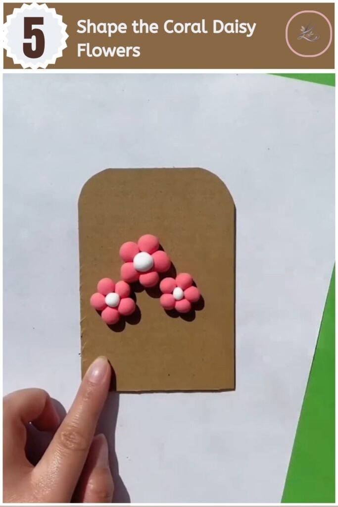 Beautiful Air Dry Clay Flower Wall Decor for Beginners Coral pink air dry clay daisy flower with white center on a wall decor tag