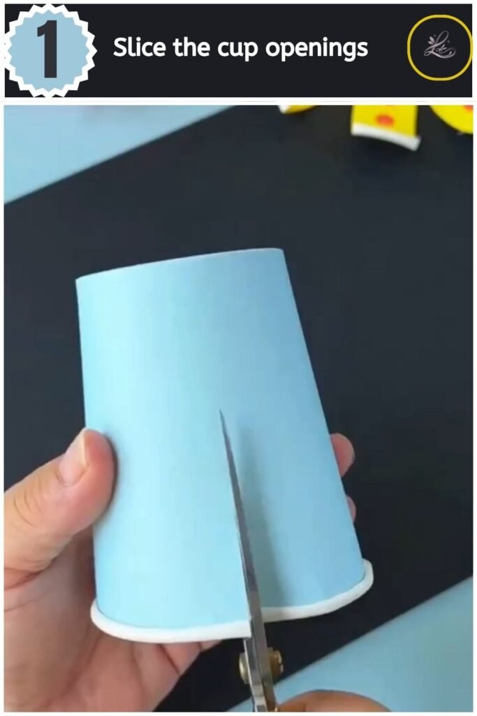 Playful Paper Cup Octopus Craft for Beginners Cutting vertical lines along the rim of a blue paper cup for an octopus craft.